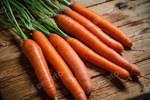 Preview: Fresh carrots on wooden table.