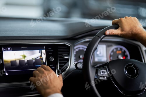 Preview: Man sitting in car and touching digital display of dashboard