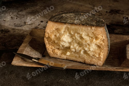 Preview: Close up of cut wheel of cheese on tray
