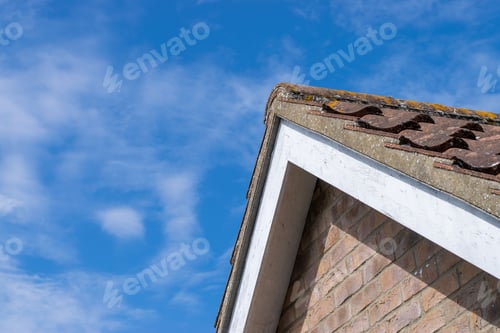 Preview: House roof close-up against blue sky.