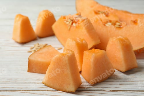 Preview: Ripe melon slices on white wooden background