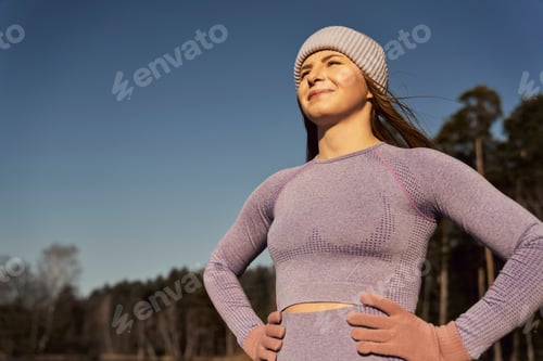 Preview: Caucasian woman taking a breath and catching sunbeams outdoors in the winter