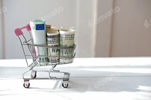 Preview: shopping cart with dollar and euro notes. business concept.