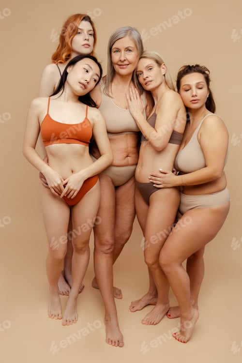 Preview: Cheerful, attractive, diverse women wearing stylish underwear, hugging and looking at camera
