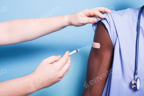 Preview: Medic uses syringe to administer vaccine