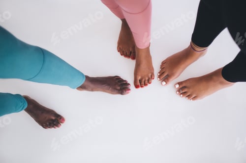 Preview: Unrecognizable barefoot women with pedicure