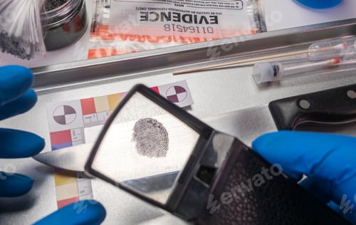 Preview: Police investigates with a magnifying glass fingerprint on a knife, conceptual image