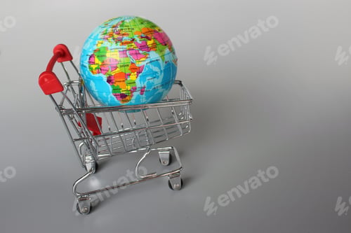 Preview: Mini shopping trolley and globe on grey background