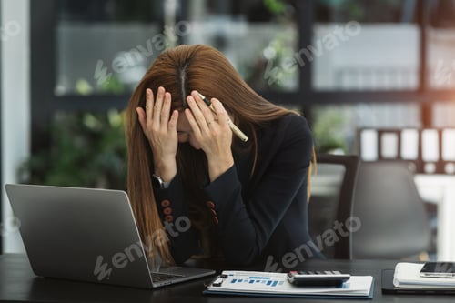 Preview: Tired asian businesswoman with headache at office, feeling sick at work.