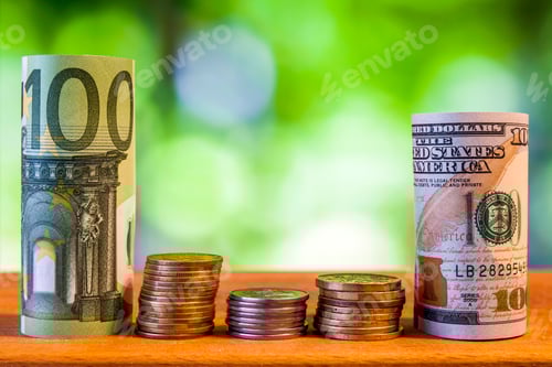 Preview: One hundred euro and one hundred US dollar rolled bills banknotes