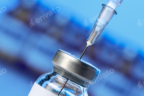 Preview: Vaccine bottle with a syringe taking the vaccine from it