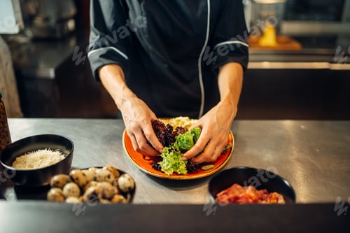 Preview: Female chef cooking meat salad on wooden table