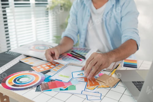 Preview: A designer is working on a creative UX UI project at a desk