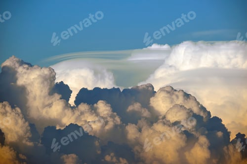 Preview: White fluffy cumulonimbus clouds forming before thunderstorm on evening sky