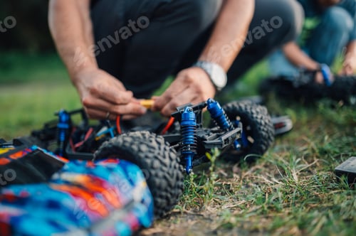 Preview: Selective focus low angle view of toy car repair outdoors.