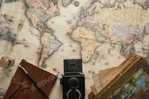 Preview: top view of vintage camera, notepad with fountain pen and painting on map background
