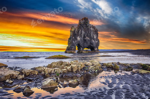 Preview: Dramatic sunset view of fHvitserkur unique basalt rock in Iceland