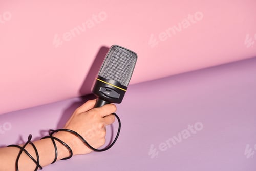 Preview: cropped view of woman holding loudspeaker on colorful background