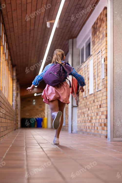 Preview: Running in school hallway, girl with backpack excitedly heading to class