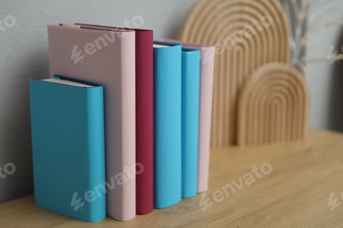 Preview: Many colorful books on wooden table indoors, closeup
