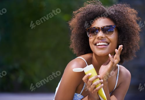 Preview: I cant believe Im finally on holiday. Shot of an attractive female holding sunscreen.