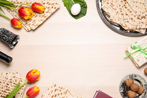 Preview: Flat lay composition with symbolic Pesach (Passover Seder) items on wooden table, space for text