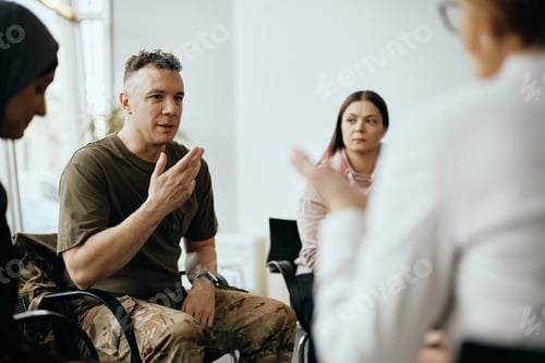 Preview: Mid adult soldier sharing his story with attenders of group therapy at mental healthcare center.