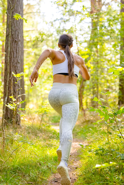 Preview: Female Running In Woodland During Outdoor Workout