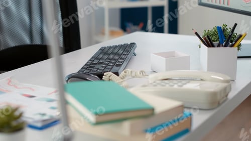 Preview: Empty company desk with landline phone and documents