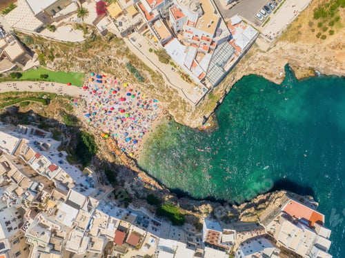 Preview: Polignano a Mare, Italy. Beach between the rocks. Aerial view of the city.