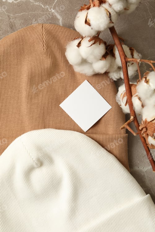 Preview: Stylish beanies and cotton on gray background