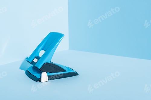 Preview: Blue Plastic Hole Puncher on Blue Background