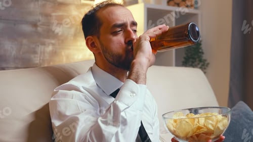 Preview: Businessman with a tie relaxing watching a comedy