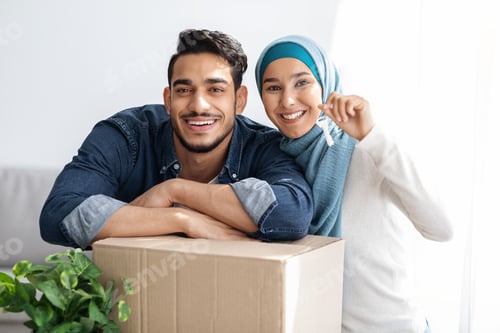 Preview: Key chain in smiling muslim couple hands, moving concept