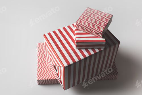 Preview: stack of christmas presents in red and white stripes, isolated on grey