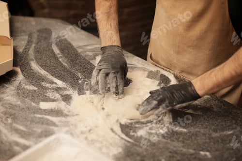 Preview: Man making pizza at table, closeup view