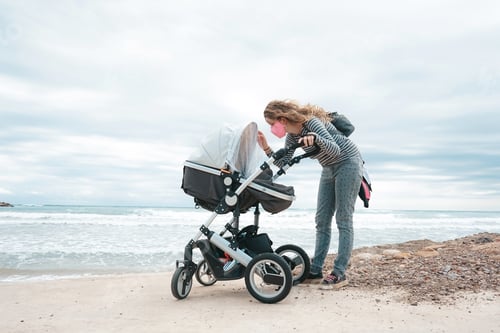 Preview: Young mom walking with her baby during covid pandemic