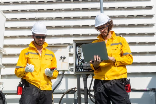 Preview: Engineers inspecting rooftop electrical equipment