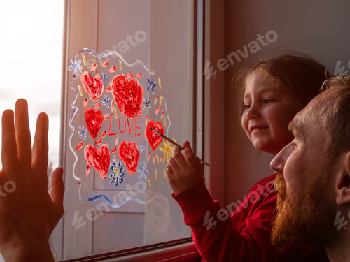 Preview: Child with father painting Love sign, playing indoors quarantine family leisure. Little girl smiles
