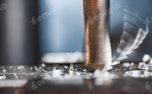 Preview: Drilling process with shavings close-up at the workplace in workshop