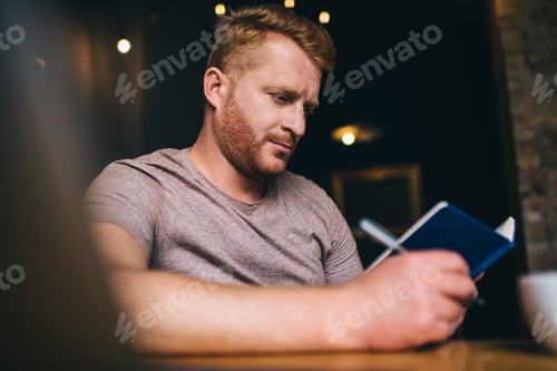 Preview: Man reading and taking notes