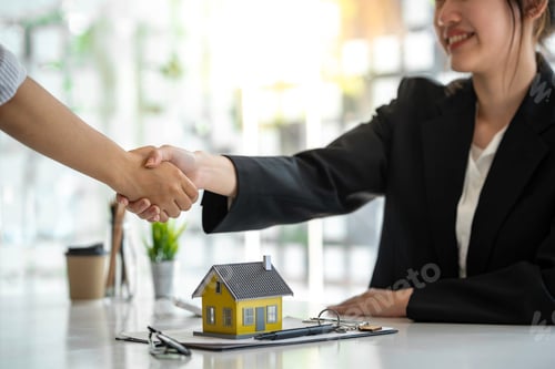 Preview: Successful deal Real estate lease or home purchase concept buyer shakes hands with bank employee aft