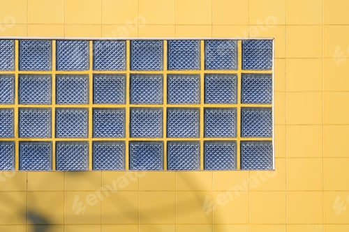 Preview: The old yellow square tile wall background with glass blocks decoration of vintage house