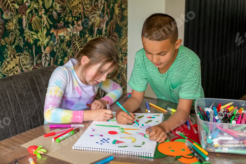 Preview: Two kids engaged in creative drawing at home