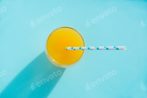 Preview: Orange fresh with color paper tube on blue background