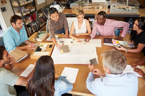 Preview: Group Of Architects Sitting Around Table Having Meeting