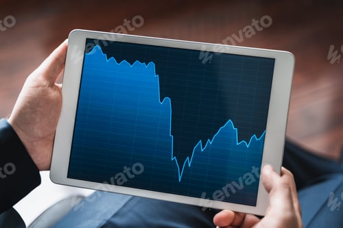 Preview: Businessman, investor,trader analyzing,looking at chart of stock prices in tablet. CEO,general manag