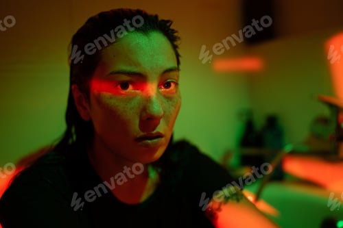 Preview: Portrait of upset depressed woman in dark bathroom under neon light, feeling lonely and empty