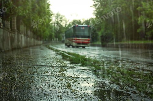 Preview: View of tram on city street under pouring rain