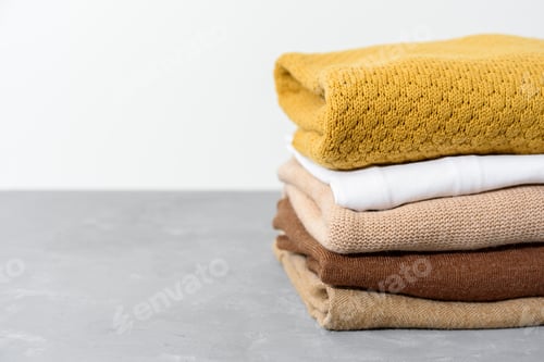 Preview: Stack of yellow and beige clothes